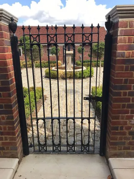 Metal side gate and railings at a property in Surrey